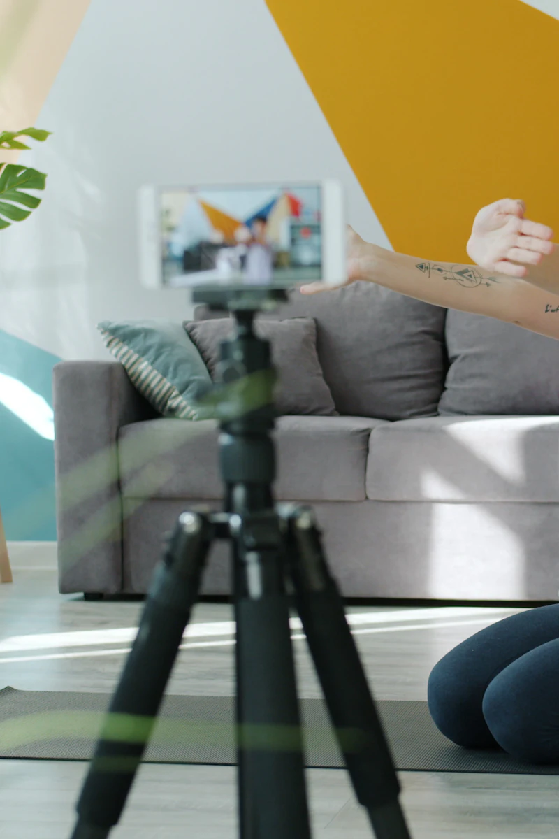 A creator recording a yoga session on a phone.