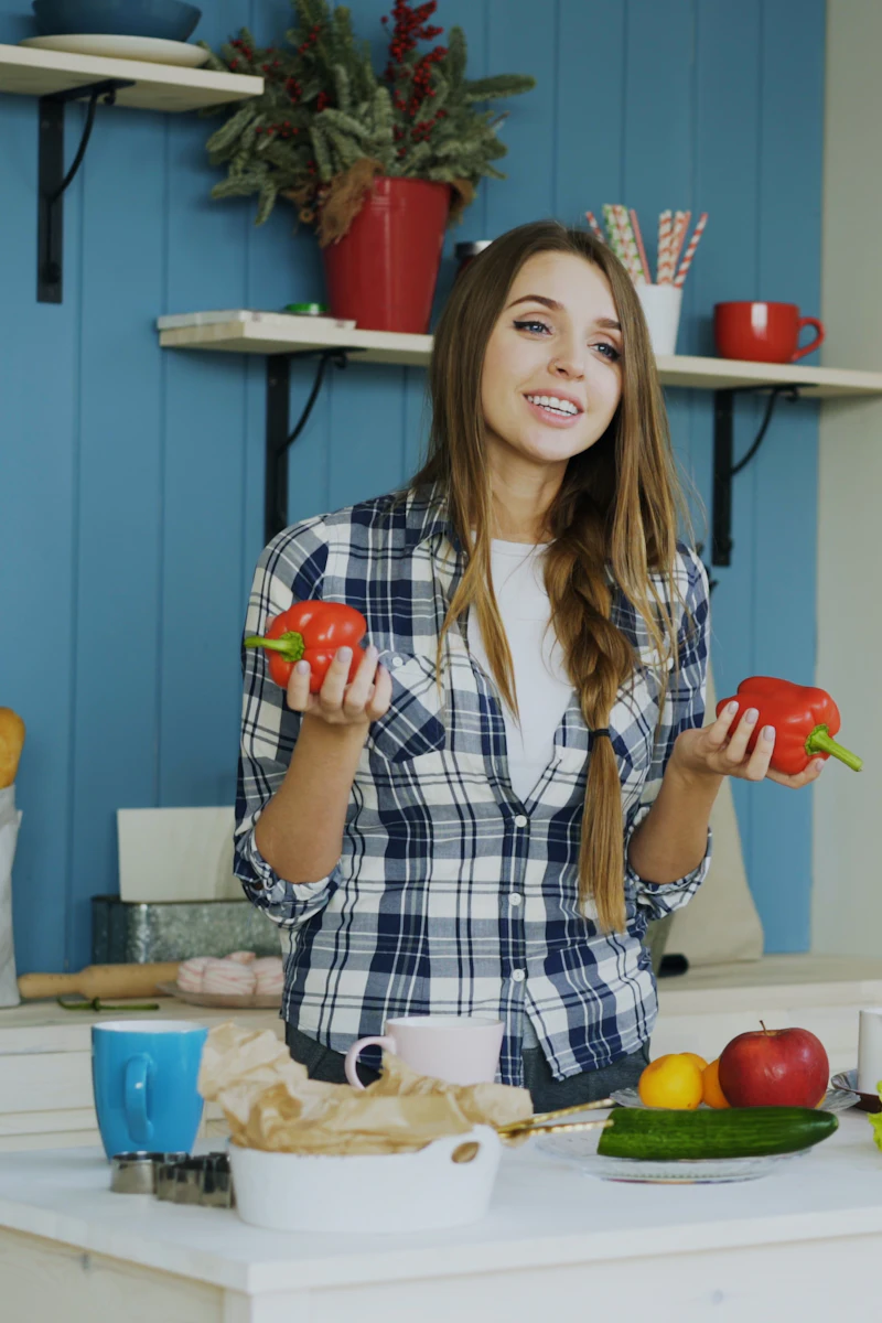 A creator presenting ingredients to camera in a kitchen.