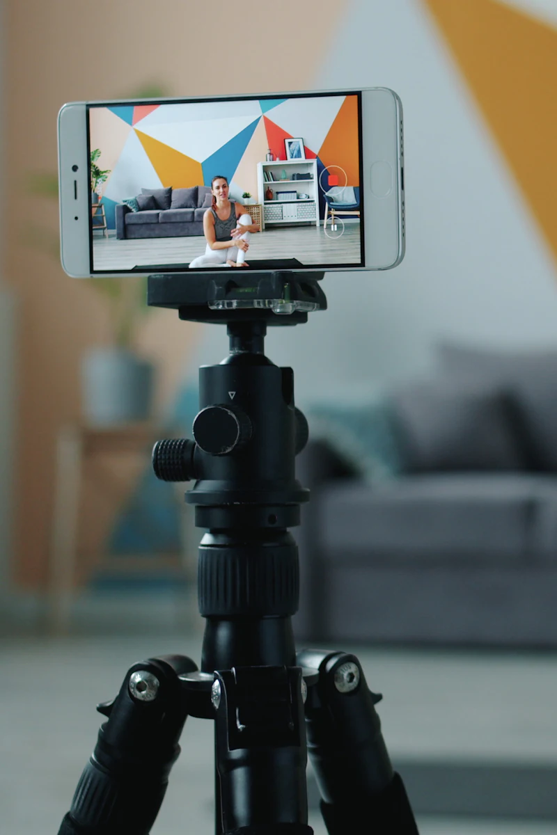A creator filming a workout with a phone on a tripod.